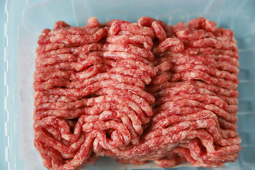 Ground beef in packing – natural or artificial cultured meat, close up