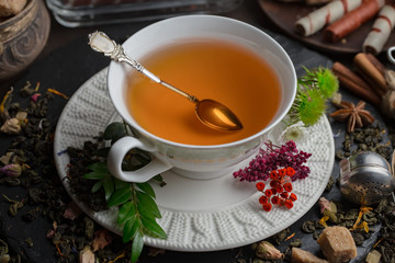 Tea hot drink on old background in composition on the table