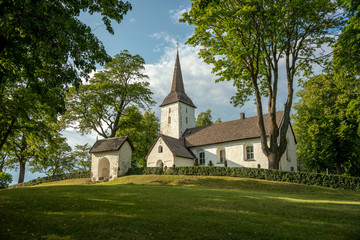 Fototapeta na wymiar The medieval church of Vallby on the Swedish countryside