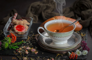 Tea hot drink on old background in composition on the table