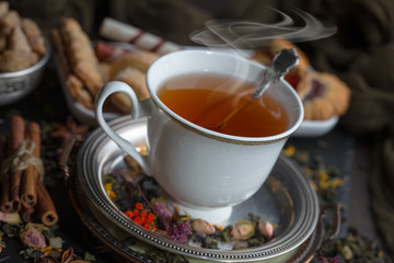 Tea hot drink on old background in composition on the table