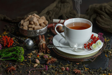 Tea hot drink on old background in composition on the table