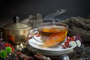 Tea hot drink on old background in composition on the table
