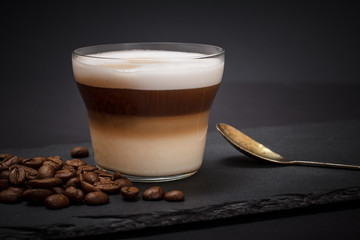 Coffee cappuccino and coffee beans on black background