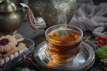 Tea hot drink on old background in composition on the table