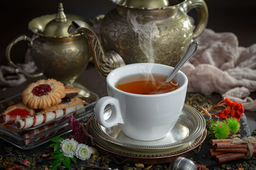 Tea hot drink on old background in composition on the table