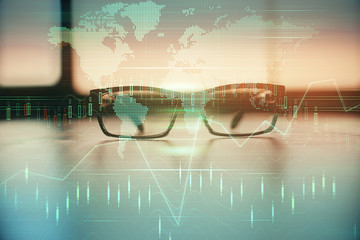 Financial graph hologram with glasses on the table background. Concept of business. Double exposure.