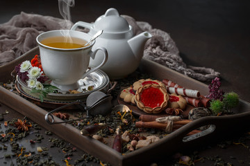 Tea hot drink on old background in composition on the table