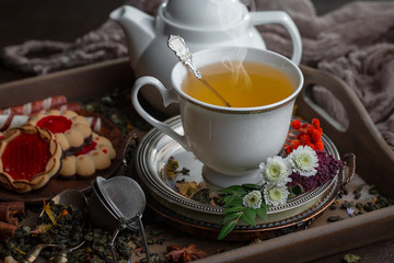 Tea hot drink on old background in composition on the table