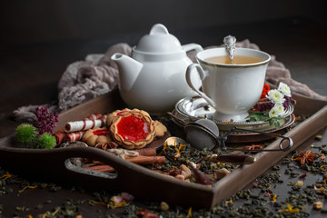 Tea hot drink on old background in composition on the table