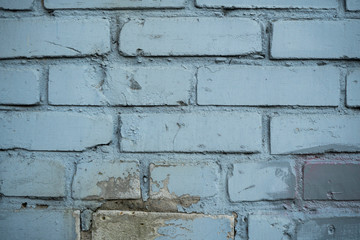 Texture of an old paint covered brick wall. Background image of an abandoned brick wall with painted over paint