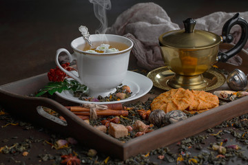 Tea hot drink on old background in composition on the table