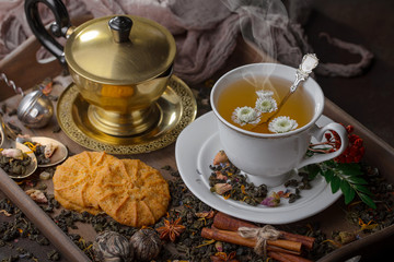Tea hot drink on old background in composition on the table
