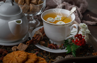 Tea hot drink on old background in composition on the table