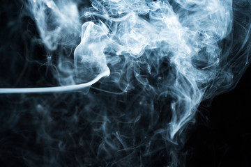 Photo of a wisp of smoke on a dark background