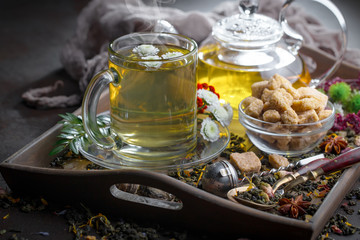 Hot tea in a cup with kitchen accessories 