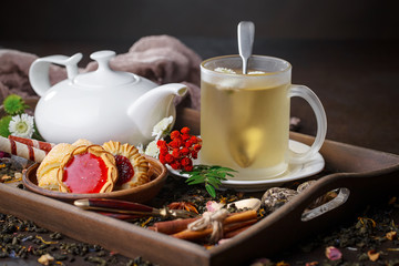 Hot tea in a cup on an old background.