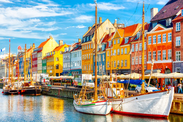 Copenhagen iconic view. Famous old Nyhavn port in the center of Copenhagen, Denmark during summer...
