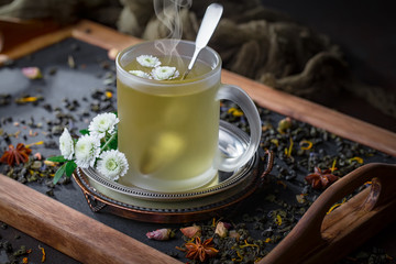 Hot tea in a cup on an old background.