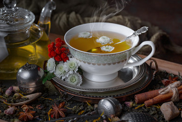 Hot tea in a cup on an old background.