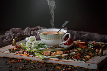 Tea hot drink on old background in composition on the table