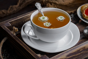 Tea hot drink on old background in composition on the table