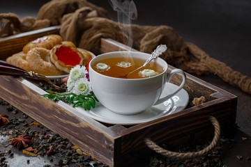 Tea hot drink on old background in composition on the table
