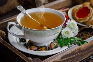 Tea hot drink on old background in composition on the table