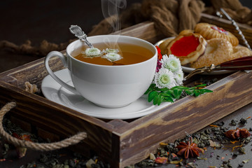 Tea hot drink on old background in composition on the table