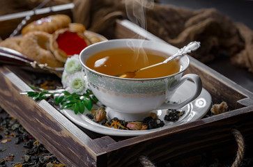 Tea hot drink on old background in composition on the table