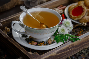 Tea hot drink on old background in composition on the table