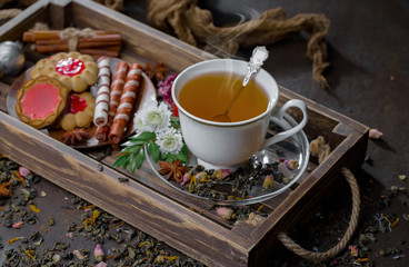 Tea hot drink on old background in composition on the table