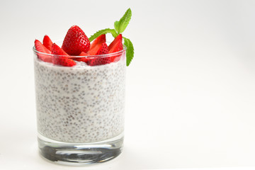 Chia pudding with strawberry and mint on a white background. Space for text or design.