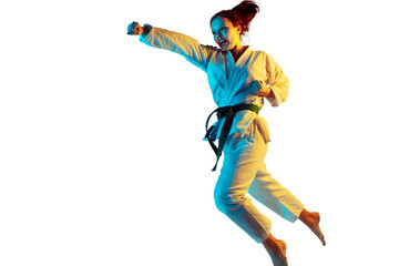 Fototapeta na wymiar Flight. Confident junior in kimono practicing hand-to-hand combat, martial arts. Young mongol fighter with green belt training on white studio background in neon. Concept of emotions, sport, action.