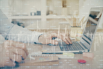 Multi exposure of stock market graph with man working on laptop on background. Concept of financial analysis.