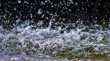 Water splash with small drops in the fountain. Abstract natural, selective focus  background