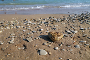 Small stones sand and sea wave.
