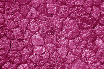 Wall made of old stones in pink tone.