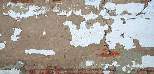 the texture of the brickwork of red brick with crumbling plaster