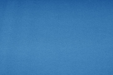 Plastic glittering texture with blur effect in navy blue tone.