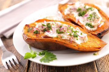 baked sweet potato with cream, onion and herbs