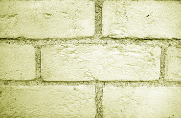 Pattern of brick wall with blur effect in yellow tone.