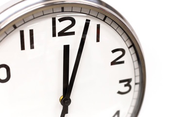 Fototapeta na wymiar Classic circle clock with clock hands showing twelve hours. Time management, procrastination, productivity concept. Close up photo.