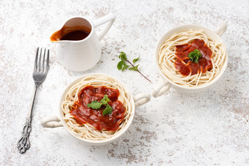 spaghetti with tomato sauce on white backdrop