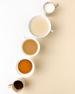 Different coffee beverages on white beige bacground
