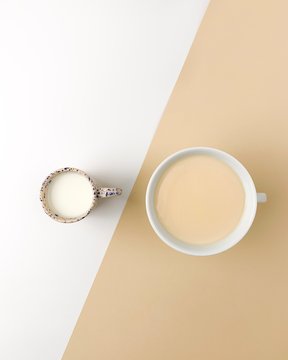 Coffee and milk on white beige bacground on a concept picture