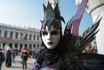 Venice, Italy - March 3, 2019: Woman dressed as Venetian carnival in San Marco Square.