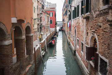 Fototapeta na wymiar Venice, Italy - March 1, 2019: Gondolas on a canal in the streets of Venice.