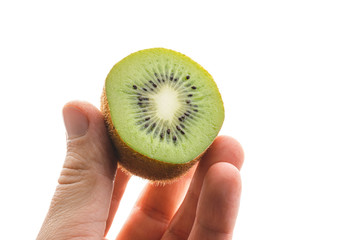 Hand holds sliced half of kiwi fruit isolated on white background