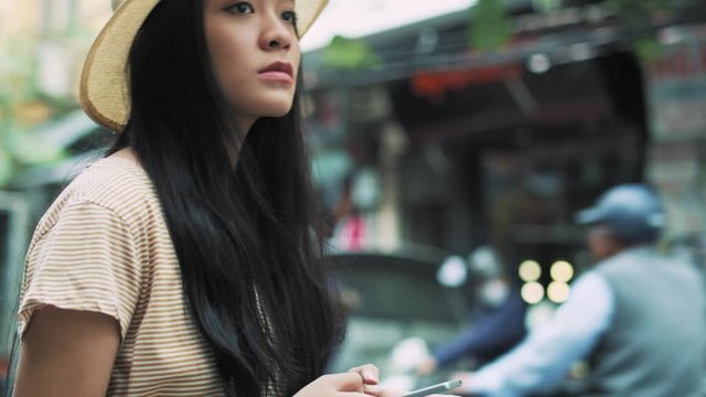 Handheld view of Vietnamese woman using smart phone 